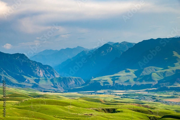 Fototapeta Highland meadows with mountain and village