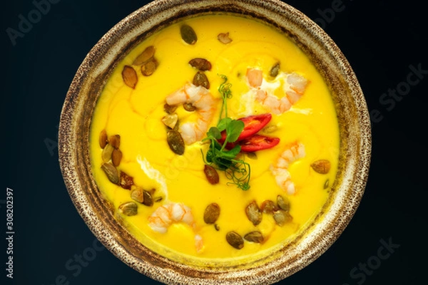 Obraz Pumpkin soup on a black background