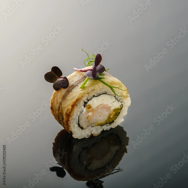 Obraz Roll with eel and shrimp on a black background