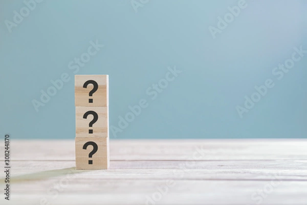 Fototapeta Wooden cube block with sign question mark symbol on wood table with with copy space