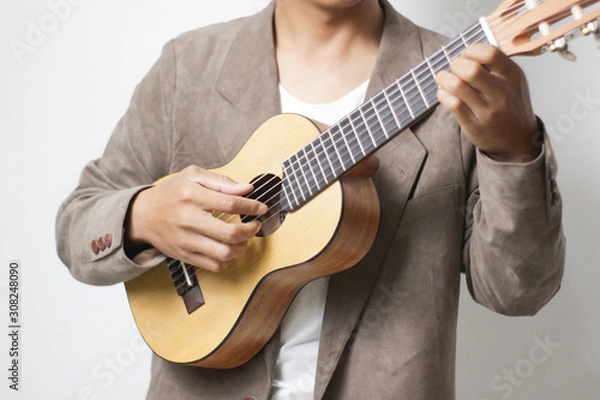 Fototapeta the guitarist is playing an acoustic guitar with blurred background