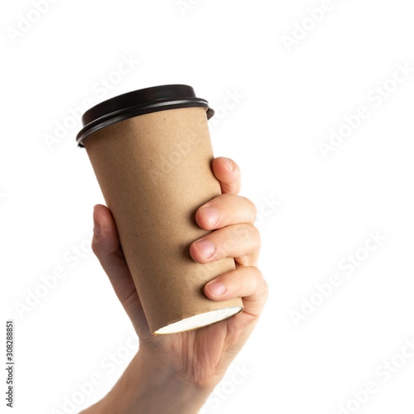 Fototapeta Man hand holding brown paper cup of coffee with black lid isolated on white background.