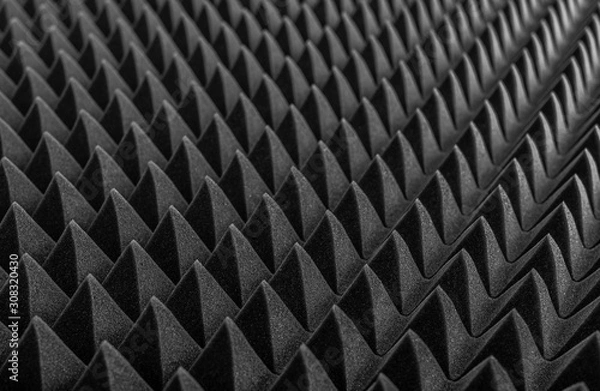 Fototapeta Abstract background in the form of pyramids and dragon scales. Acoustic black foam rubber.