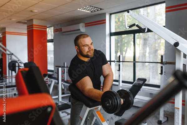 Obraz Young handsome man engaged in the gym