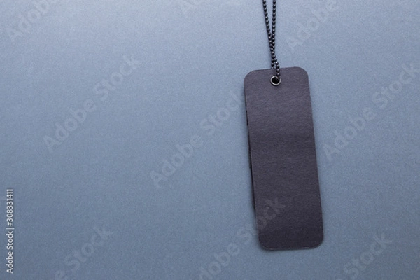Fototapeta Black label on gray isolated background close-up.