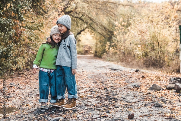 Fototapeta Little girls smile and enjoy life on an autumn day, friendship, sisters, relationships, family
