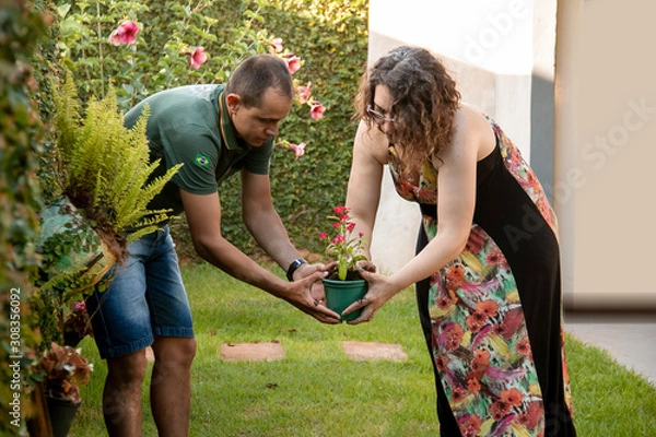 Fototapeta Couple in casual time at home, dating in the garden.