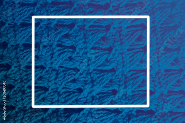 Obraz knitted woolen scarf clothing textile canvas for design closeup. Classic blue pantone 2020