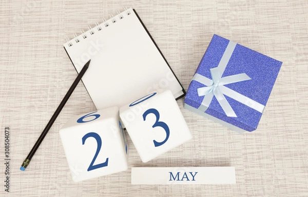 Fototapeta Calendar with trendy blue text and numbers for May 23 and a gift in a box.