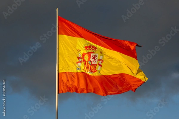 Fototapeta Spanish flag Waving in the Wind with Blue Sky and Clouds Cadiz Andalusia