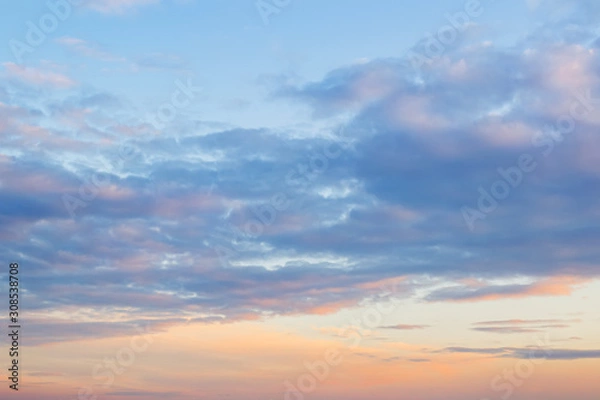 Fototapeta Golden blue sunset sky with light clouds. Vanilla sky. Tranquil skyscape just before the sundown. Pastel scenic cloudscape for background.