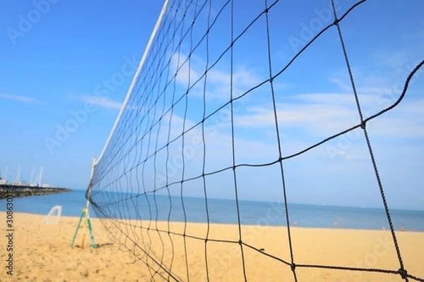 Fototapeta Close up of volleyball net with sea beach and blue sky in summer. Nature, outdoor and sport concept.