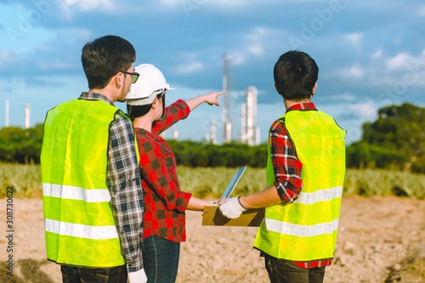 Obraz Young woman worker hand notebook and Young man and for check soil for planting pineapple farm for into production factory industrial.