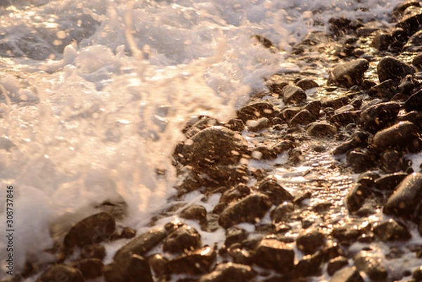 Obraz Volcanic pebbles on the ocean close up at sunset. The stones. Sea. Ocean.