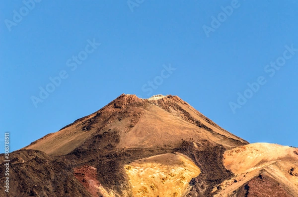 Fototapeta Crater Of The Highest Peak Behind Formations Of Lava Rocks On A Sunny And Very Clear Day In El Teide National Park. April 13, 2019. Santa Cruz De Tenerife Spain Africa. Travel Tourism Street