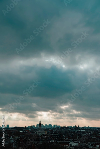 Fototapeta Old centre of the city of Amsterdam under cloudy sky in autumn. High angle view.