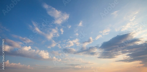Fototapeta Blue sky clouds background. Beautiful landscape with clouds and orange sun on sky