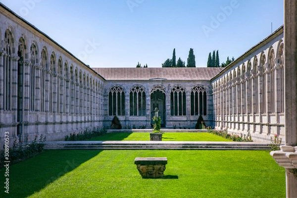 Fototapeta View from gallery on internal garden, Camposanto Monumentale di Pisa. Monumental Cemetery courtyard. Ornate columns and arches. Pisa, Italy, Tuscany