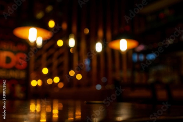 Fototapeta Blurred background in modern cafe, bokeh of lights.