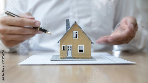 Fototapeta House model with agent asking costumer for contract to buy, get insurance or loan real estate or property.