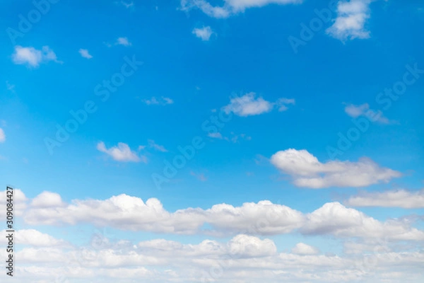 Fototapeta Deep blue sunny sky with white clouds. Blue sky with cloud closeup. White fluffy clouds in the blue sky.
