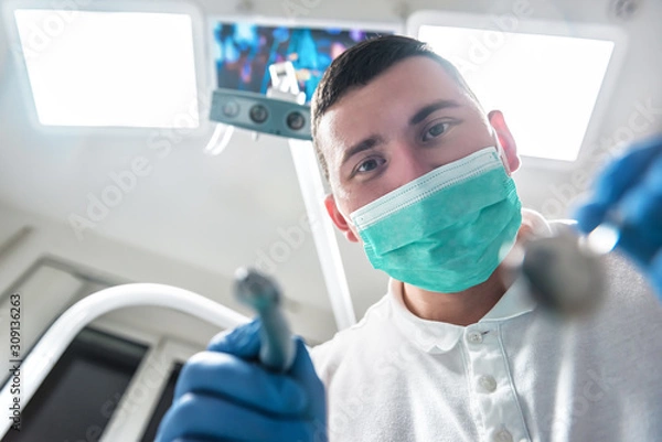 Fototapeta professional dentist treats the patient's teeth