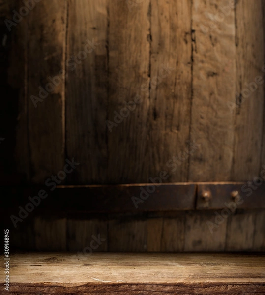 Fototapeta Wooden barrel on a table and textured background