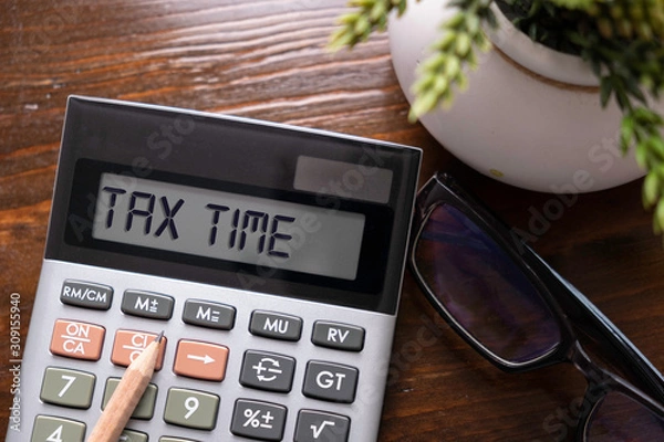 Fototapeta Calculator with text Tax Time. Business, finance conceptual. 