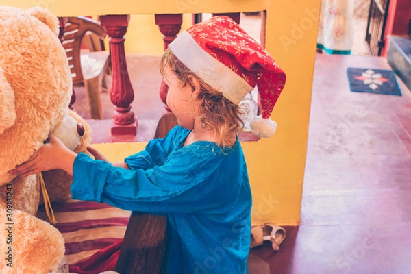 Obraz Joyful child in Santa hat.