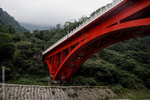 Fototapeta red bridge through the mountain