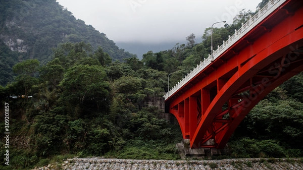 Fototapeta red bridge through the mountain