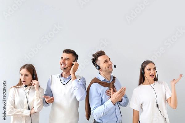 Fototapeta Team of technical support agents on light background