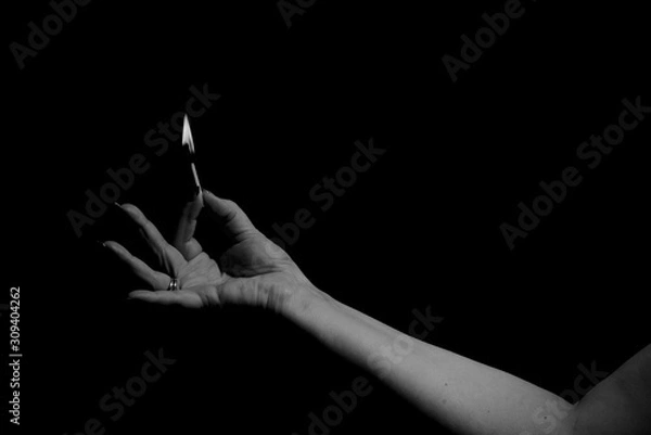 Obraz Burning match held in between fingers