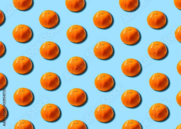 Obraz Citrus concept. Orange mandarins repeats on a soft blue background. 