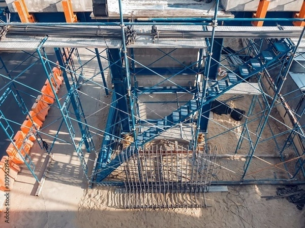 Fototapeta The temporary staircase was built for the construction with prevent falling. scaffolding in the construction zone