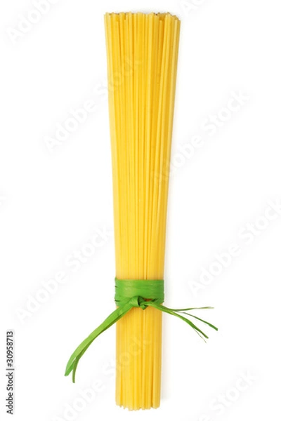 Fototapeta Bunch of spaghetti tied up with green ribbon isolated on white