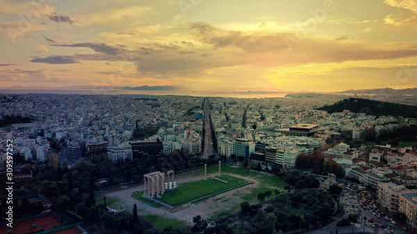 Fototapeta Aerial drone photo of iconic ruins of Temple of Zeus in Athens historic centre at dusk with beautiful sky and colours and Syggrou avenue at the background, Attica, Greece