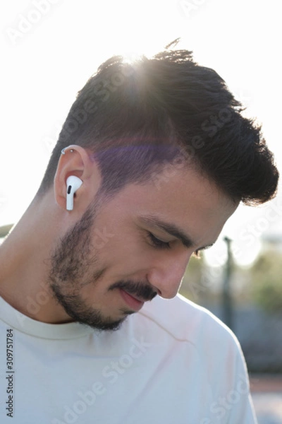 Obraz New Apple Airpods Pro outdoor images, showing with a person on-ear. 03.12.2019 Bornova, Izmir, Turkey