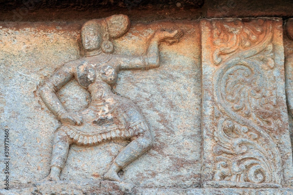 Fototapeta Dancing girl and beautiful design Carved in the stone, on the wall of Mahanavami dibba, Hampi , INDIA