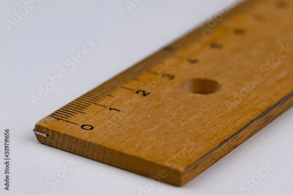 Obraz A wooden ruler on a white table