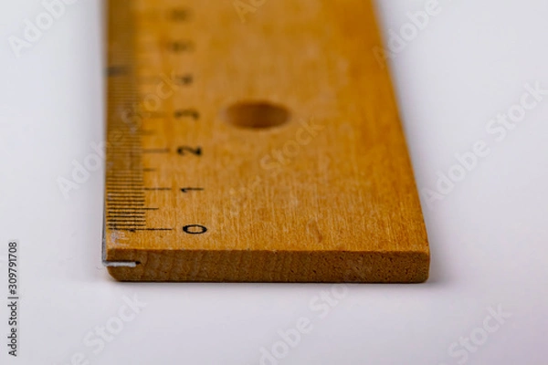 Obraz A wooden ruler on a white table