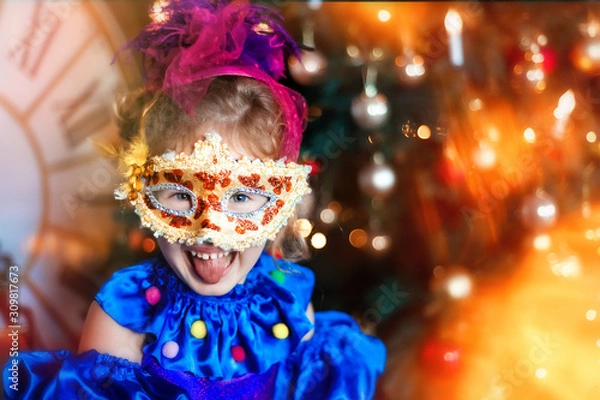 Obraz Portrait of funny laughing 4 years old girl in carnival venetian mask. Christmas tree, big clock on background. Christmas lights. Space for text. Happy and funny christmas and new year in childhood