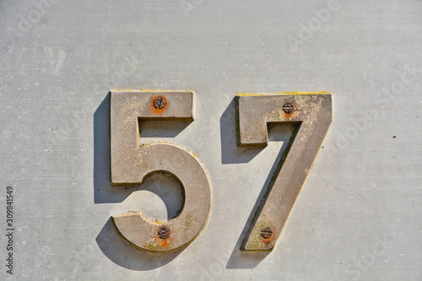 Fototapeta A house number plaque, showing the number fifty seven (57)