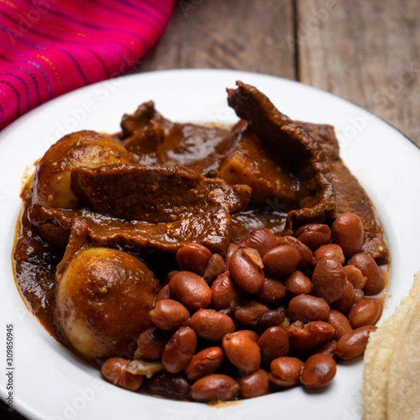 Fototapeta Mexican beef steak with potatoes and pasilla pepper sauce