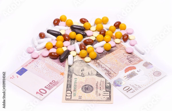 Fototapeta Different types of pills are located in dollars, euros and pounds sterling.Vitamins, tablets and dieta supplements of different colors. The production and sale of drug large amounts of mone