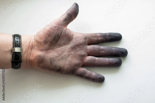 Fototapeta A male hand without gloves in ink from a printer. Indelible paint. Clear lines on the hand, palm reading. Blonny background, natural light. Dirty open left palm.