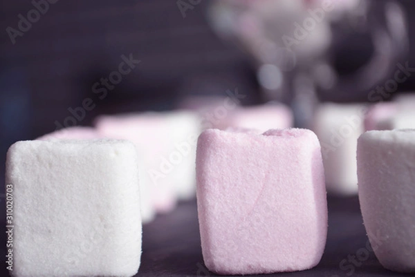 Fototapeta Hot winter drink with candies, Christmas or New Year decorations, dark background, rustic style, colored marshmallows.