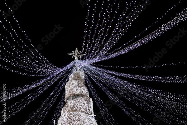 Obraz Modern glowing Christmas tree on black background.