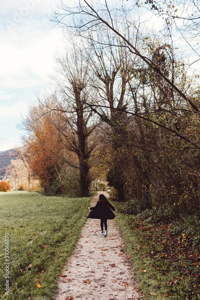 Fototapeta Lady running on a path in the countryside