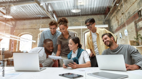 Obraz We have great results. Group of young cheerful business people in casual wear working together on new project while sitting in the creative office